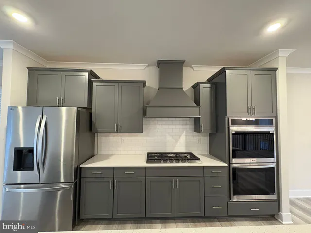 a kitchen with refrigerator and cabinets