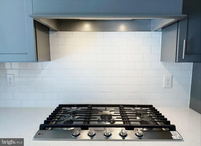 a stove top oven sitting inside of a kitchen