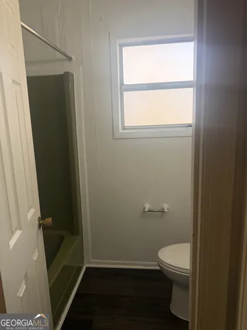 a bathroom with a toilet and a shower