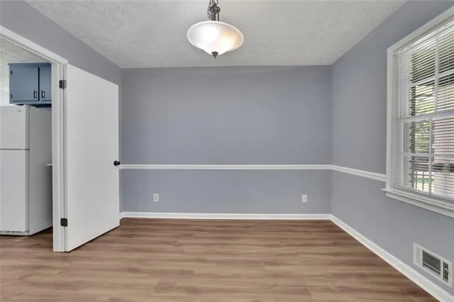 a view of room with window and wooden floor