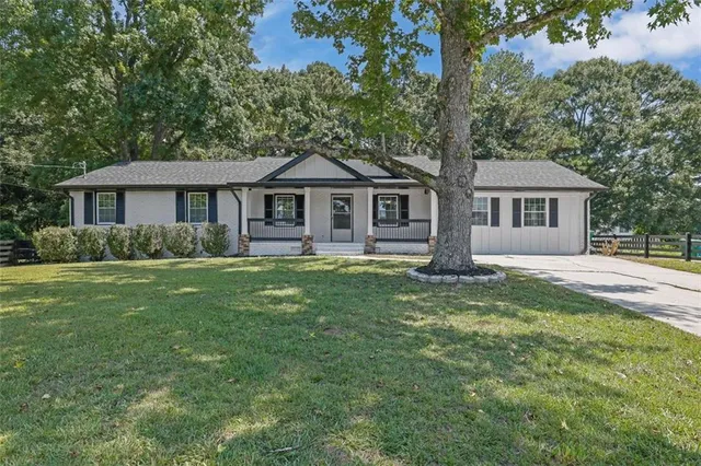 a front view of house with yard and green space