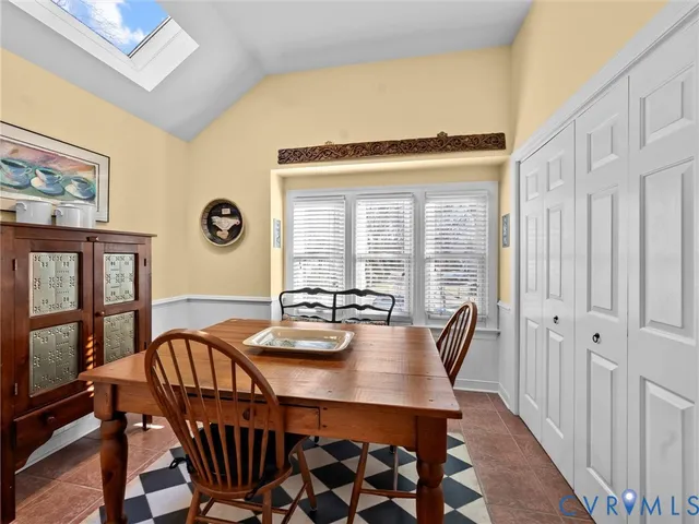 a view of a kitchen with kitchen island a table and chairs