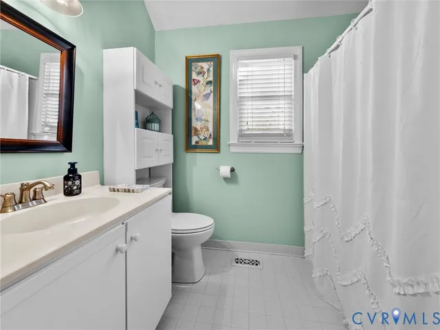 a view of a house with street next to a yard