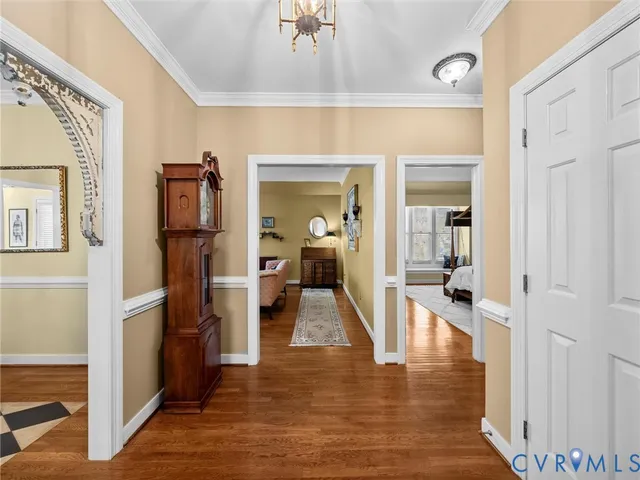a view of a hallway with wooden floor and a dining room