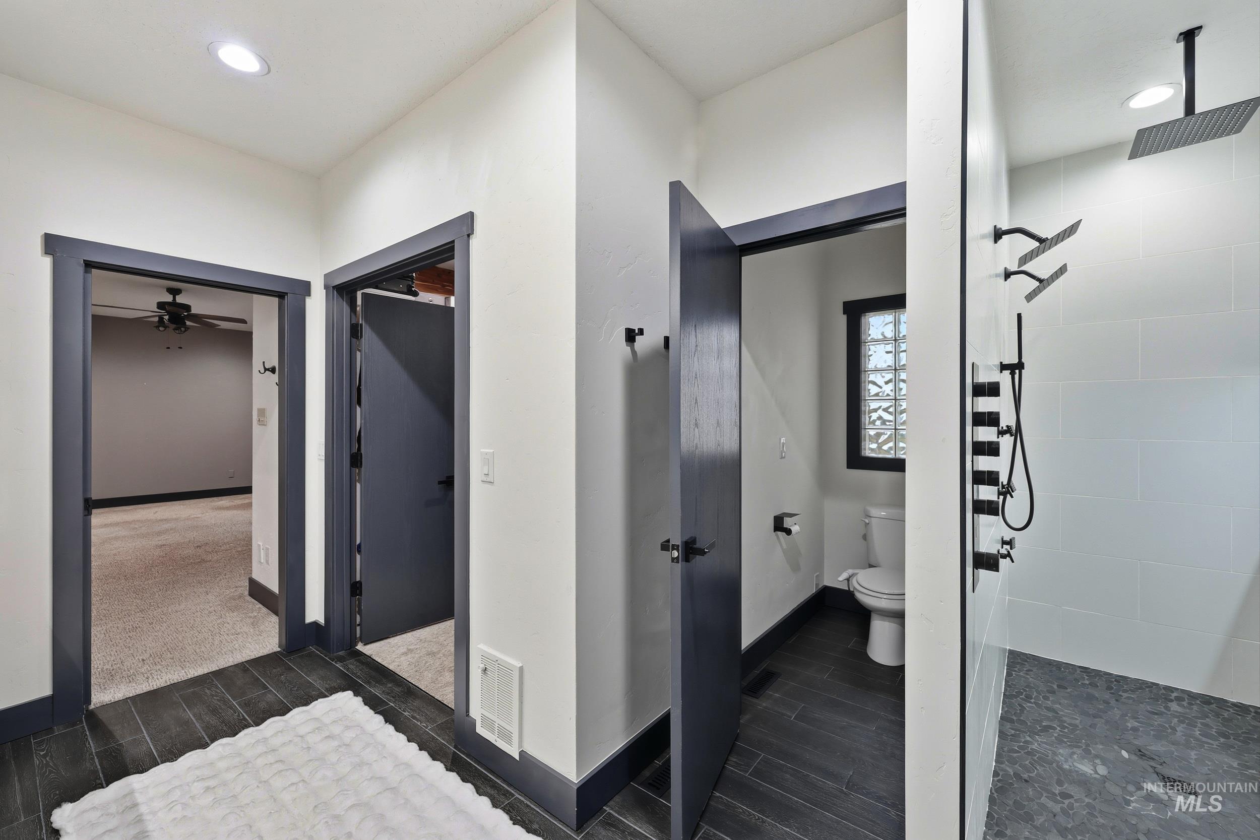 25300 Harvey Road Caldwell, ID 83607 - Photo 14 of 50 Bathroom with wood finish floors, tiled shower, and recessed lighting