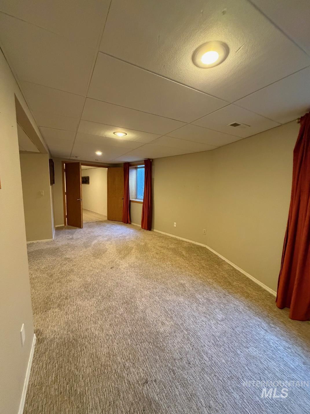 25300 Harvey Road Caldwell, ID 83607 - Photo 23 of 50 Spare room with a drop ceiling and light carpet