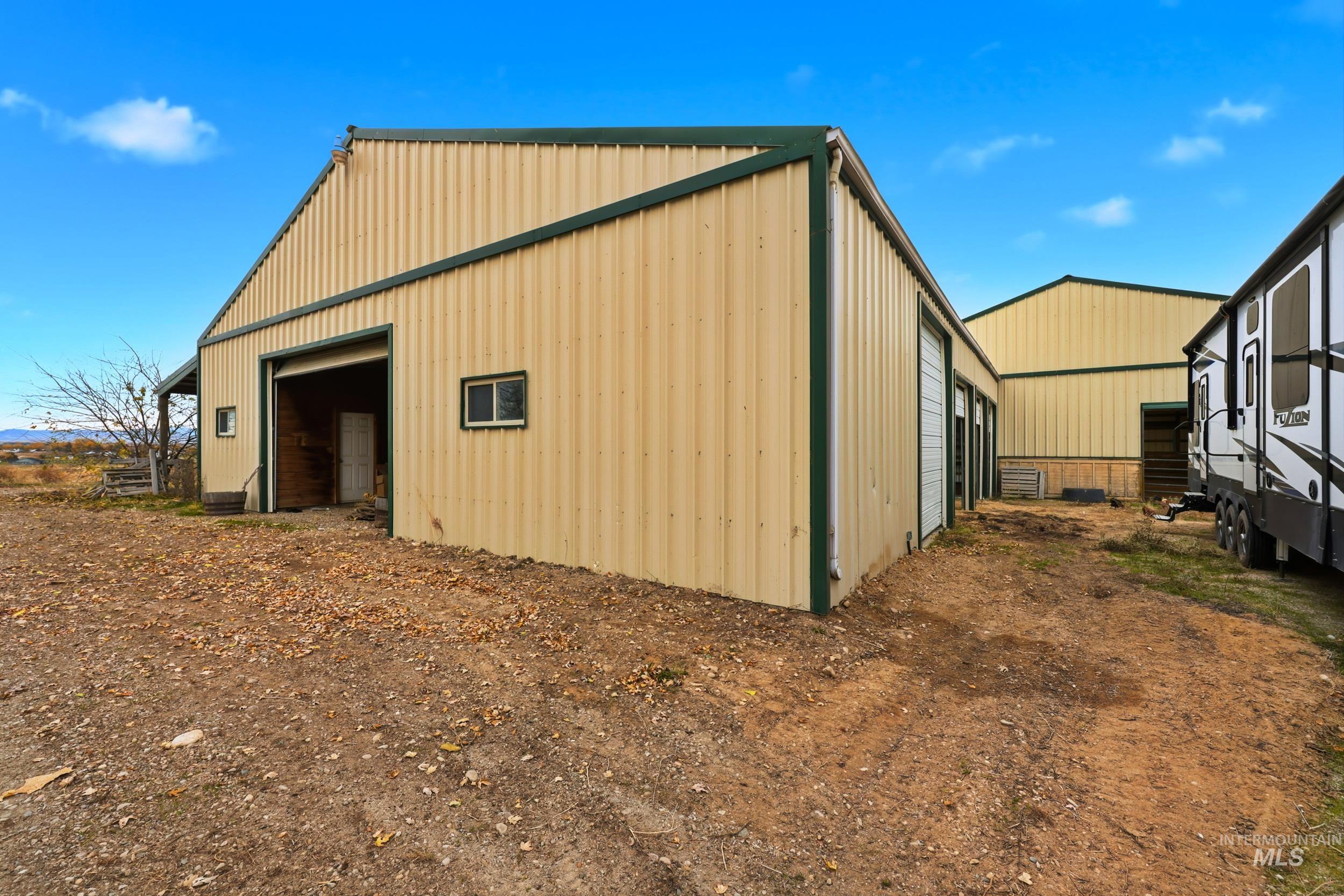 25300 Harvey Road Caldwell, ID 83607 - Photo 40 of 50 View of side of home featuring an outbuilding, an outdoor structure, and board and batten siding