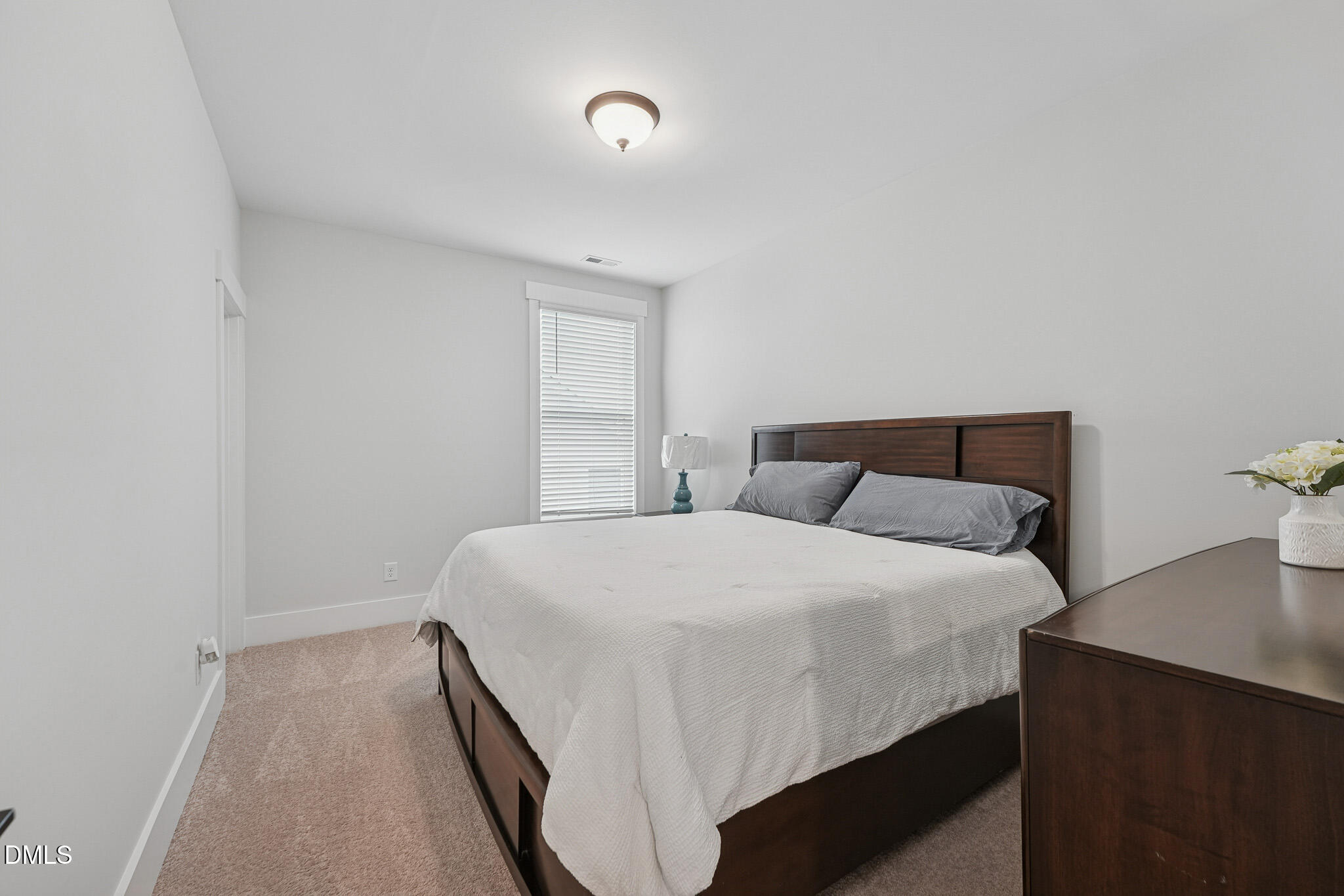 5208 Windmere Chase Drive Raleigh, NC 27616 - Photo 28 of 42 a bedroom with a bed and a night stand