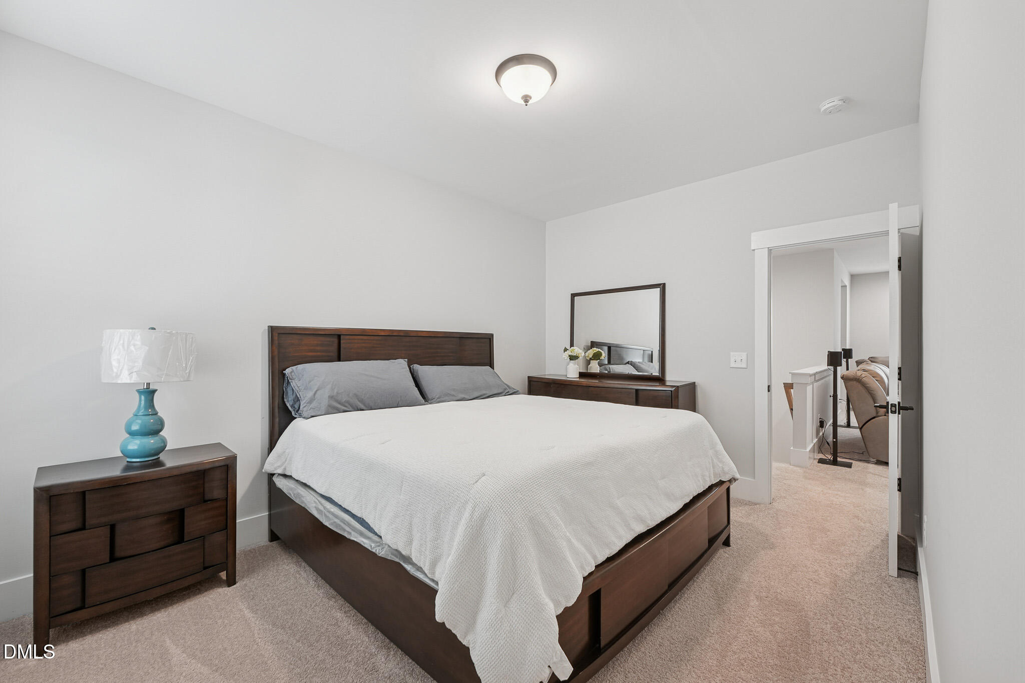 5208 Windmere Chase Drive Raleigh, NC 27616 - Photo 29 of 42 a bedroom with a bed and a lamp on dresser