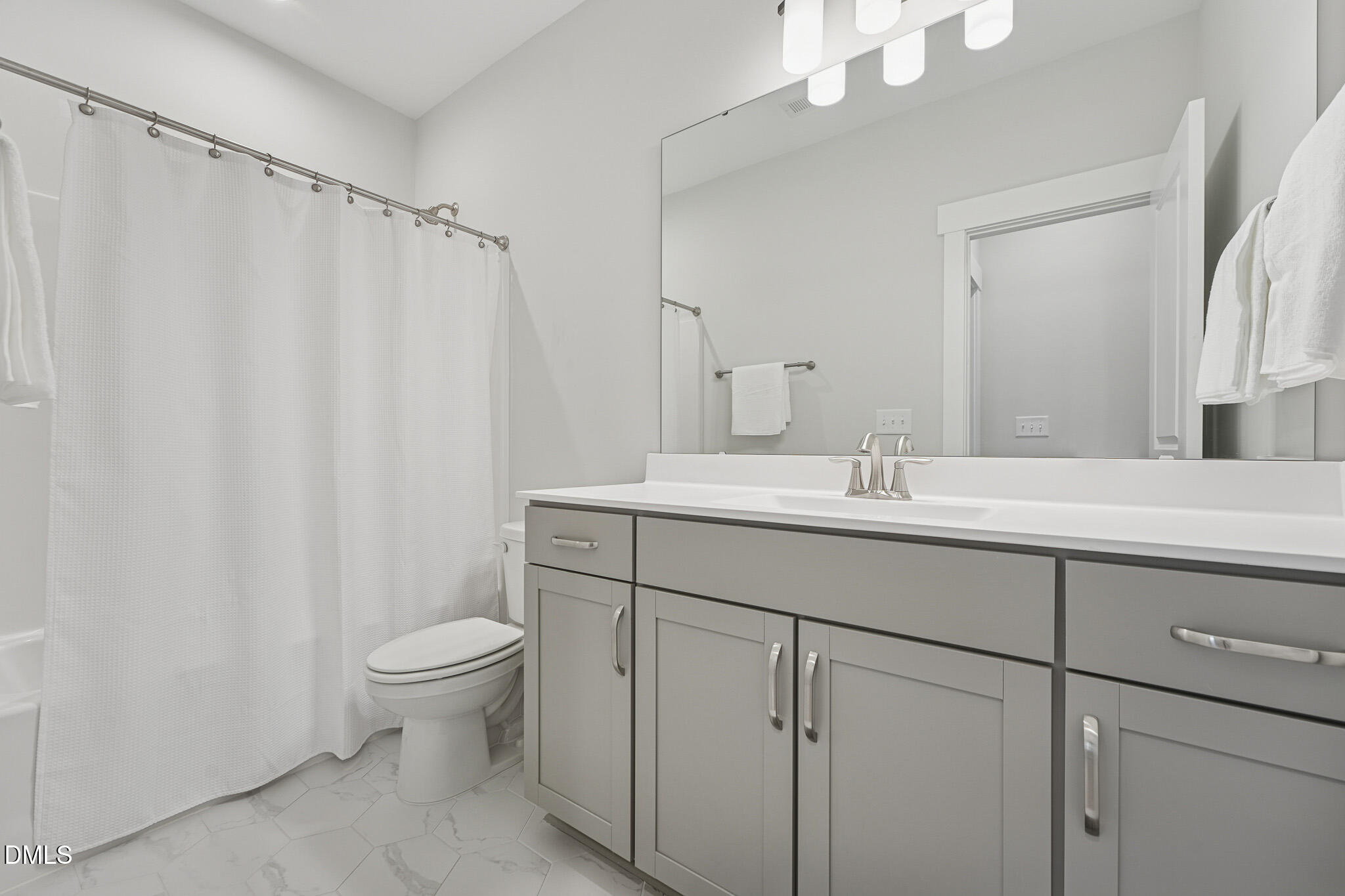 5208 Windmere Chase Drive Raleigh, NC 27616 - Photo 30 of 42 a bathroom with a sink toilet and shower