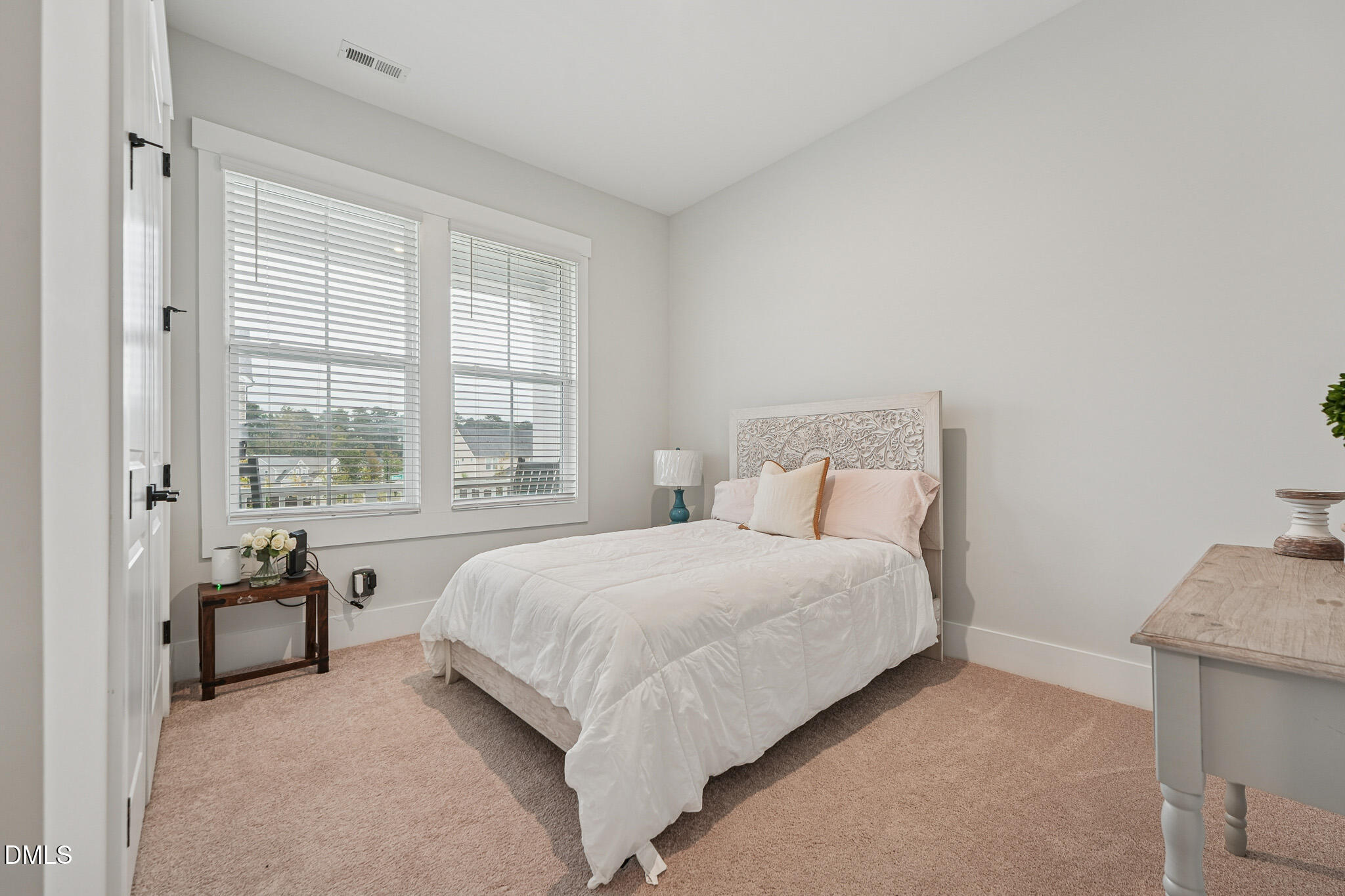 5208 Windmere Chase Drive Raleigh, NC 27616 - Photo 5 of 42 a bedroom with a bed and a large window