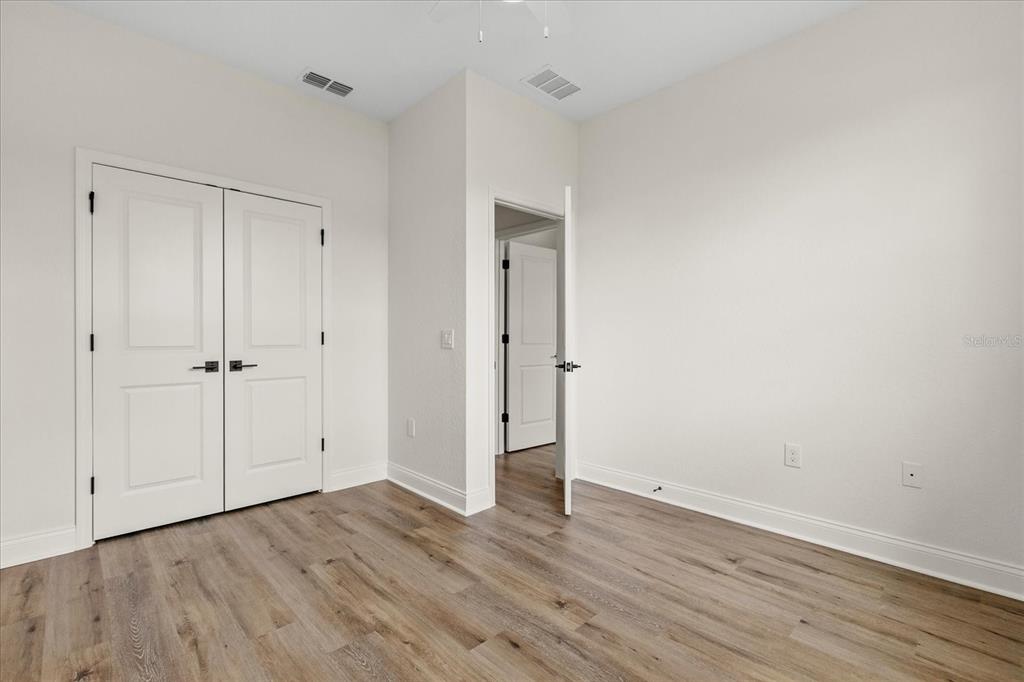 4457 Romano Street Sebring, FL 33872 - Photo 14 of 23 a view of an empty room with wooden floor