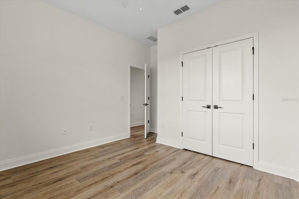 4457 Romano Street Sebring, FL 33872 - Photo 16 of 23 a view of an empty room with wooden floor