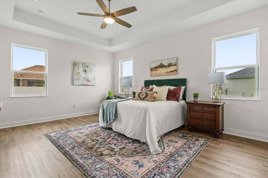 4457 Romano Street Sebring, FL 33872 - Photo 21 of 23 a bedroom with a bed and wooden floor