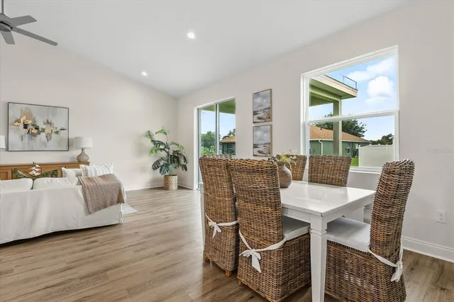 a view of a dining room with furniture large windows and wooden floor