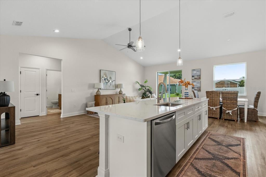4457 Romano Street Sebring, FL 33872 - Photo 5 of 23 a kitchen with stainless steel appliances a sink stove and wooden floor
