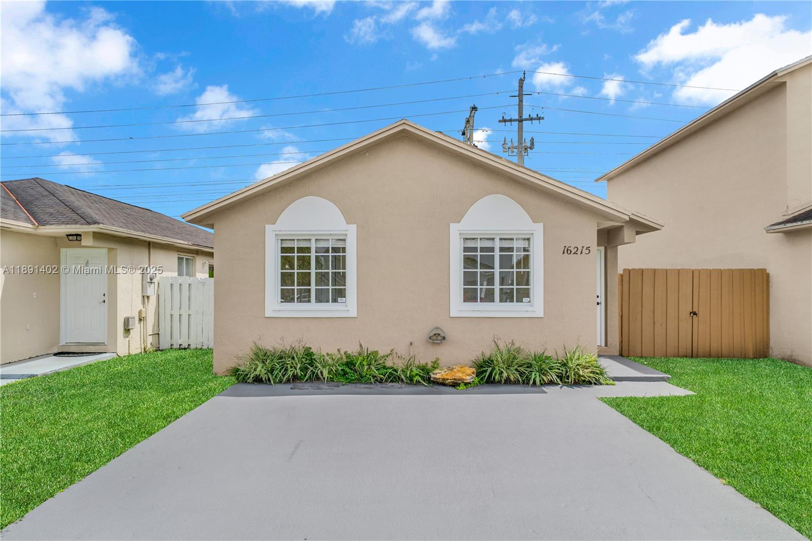 16215 Southwest 137th Court Miami, FL 33177 - Photo 2 of 30 a front view of a house with a yard and garage