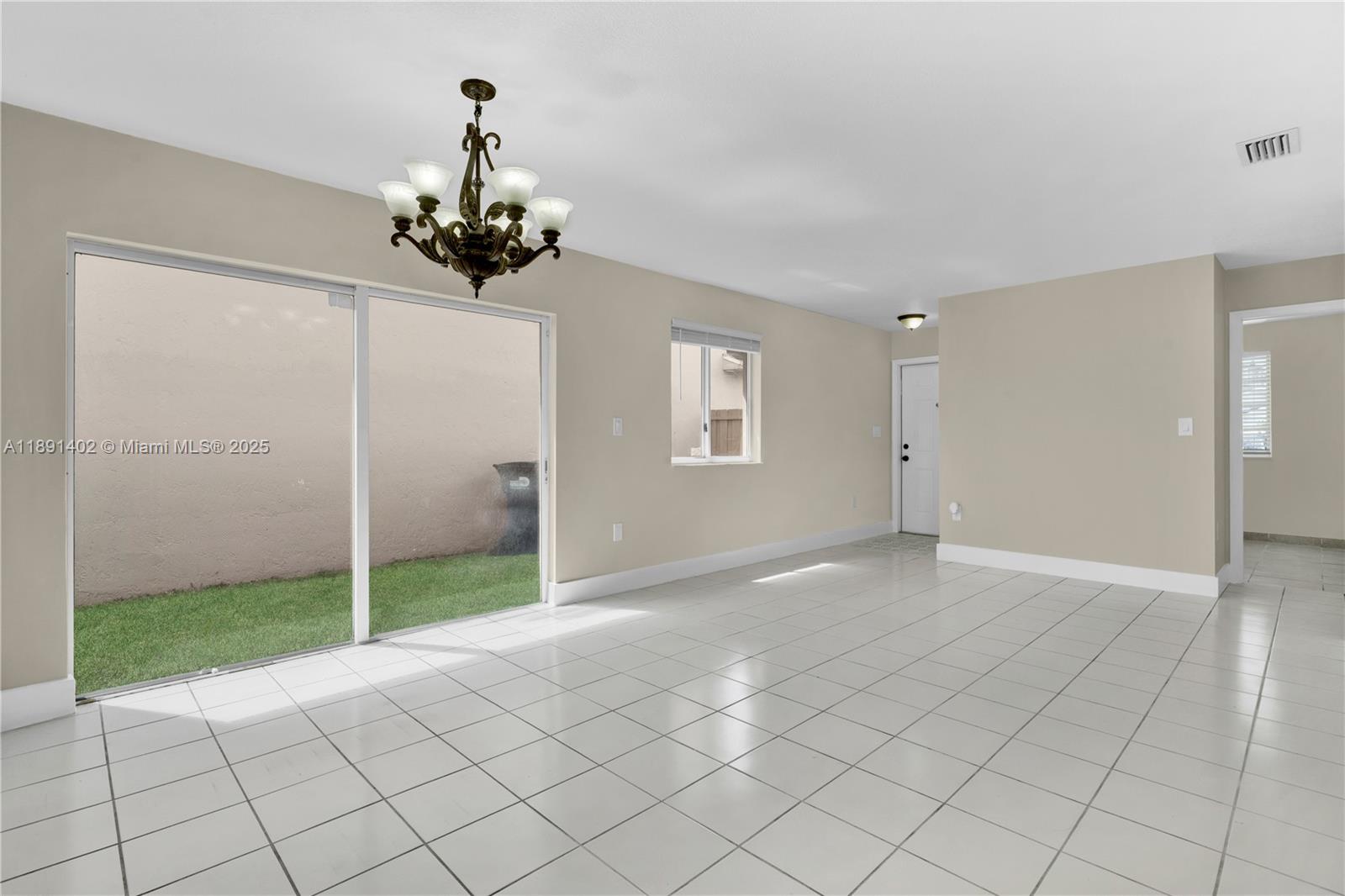 16215 Southwest 137th Court Miami, FL 33177 - Photo 8 of 30 a view of a livingroom with a chandelier fan and windows