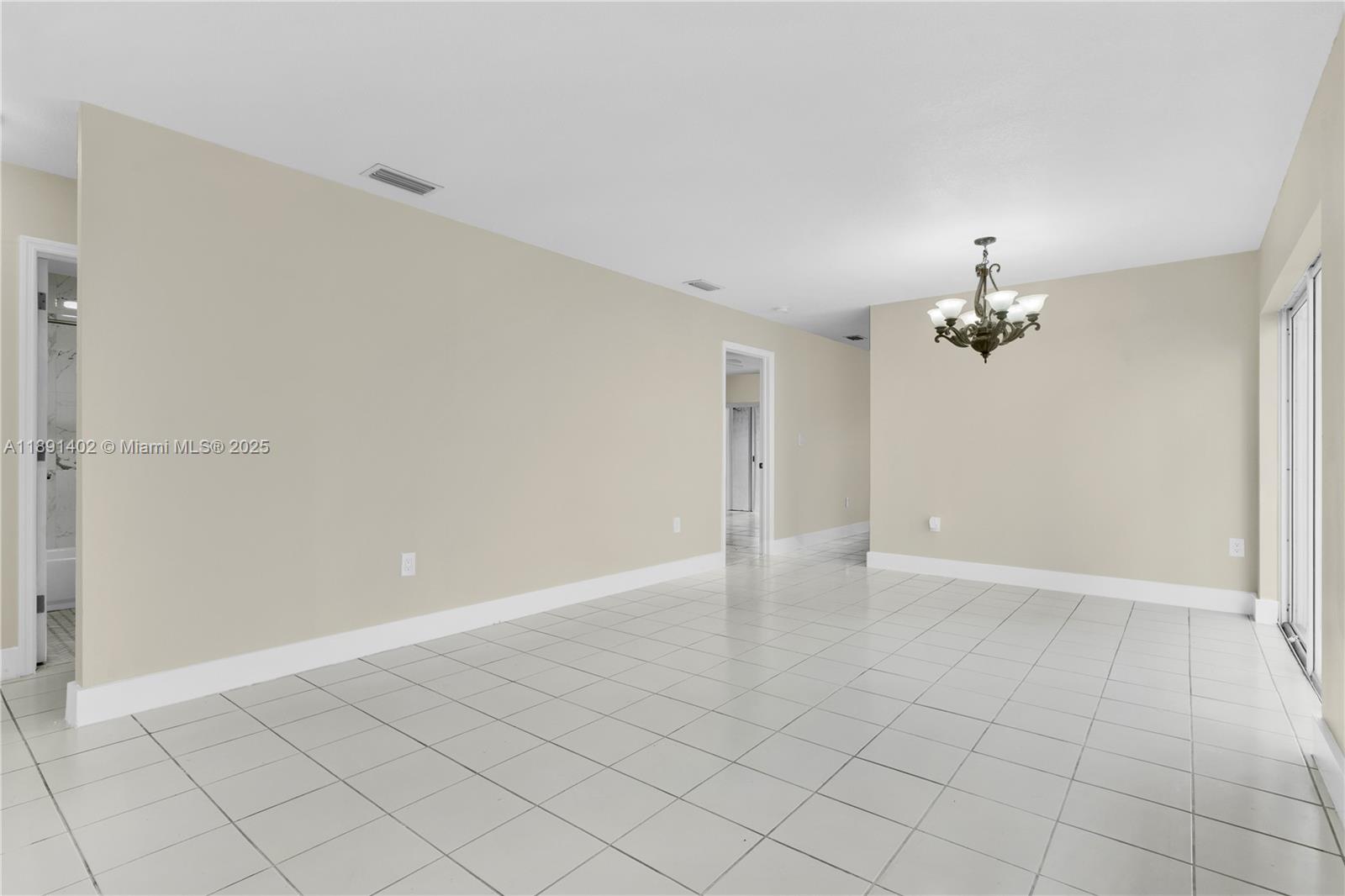 16215 Southwest 137th Court Miami, FL 33177 - Photo 10 of 30 wooden floor in an empty room with a chandelier fan