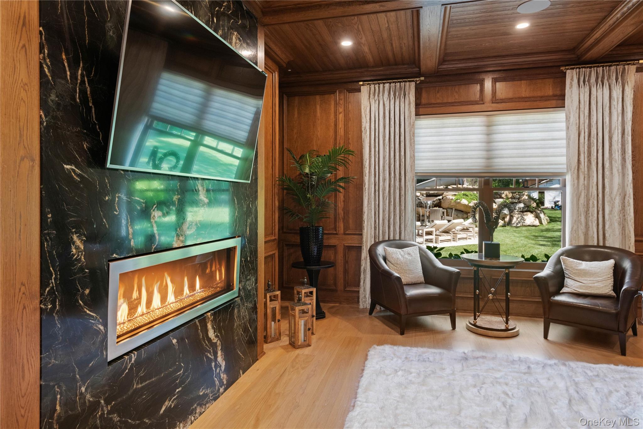 471 Woodbury Road Cold Spring Harbor, NY 11724 - Photo 12 of 36 a living room with furniture a flat screen tv and floor to ceiling window