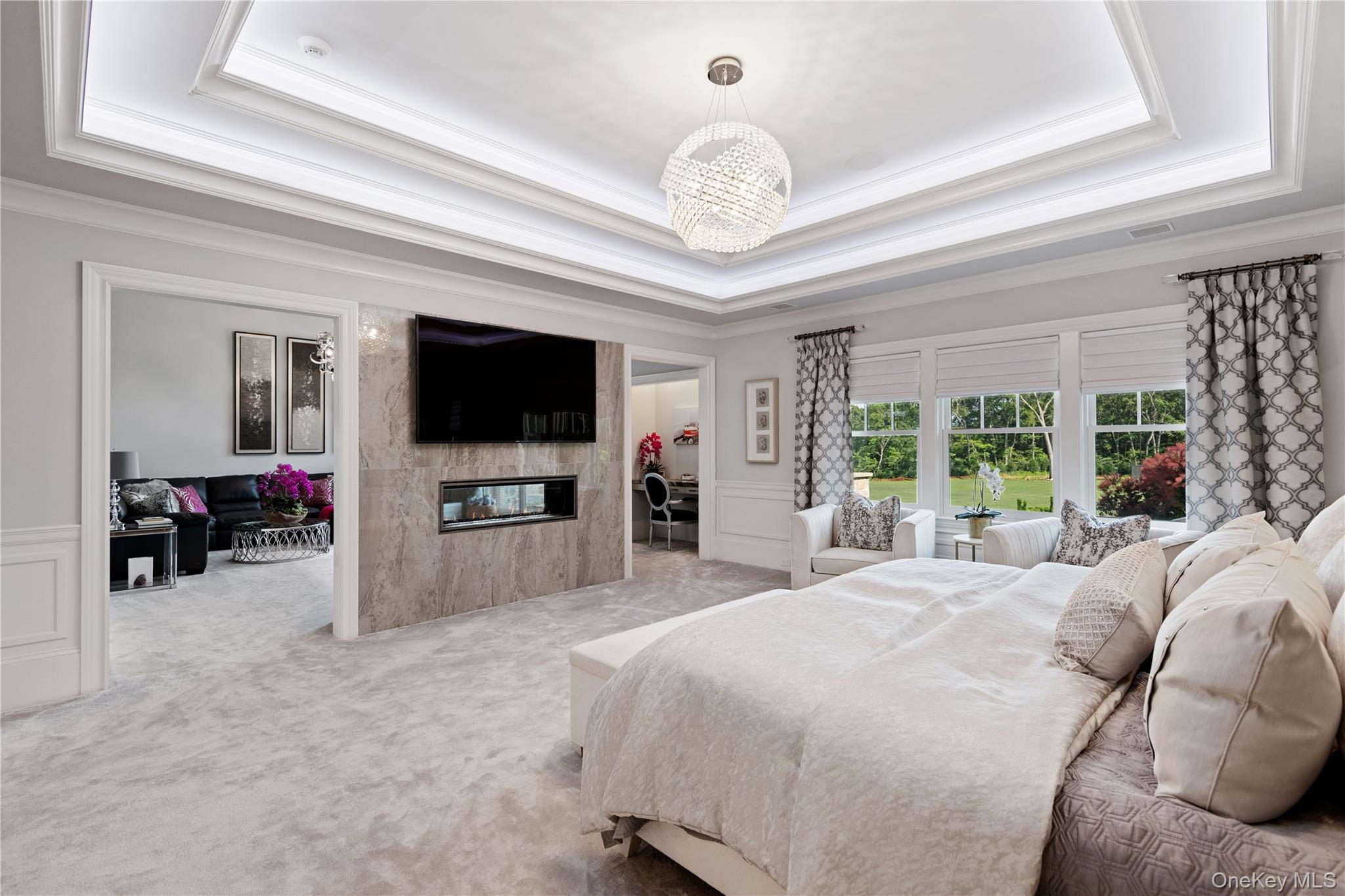 471 Woodbury Road Cold Spring Harbor, NY 11724 - Photo 13 of 36 a large bedroom with a bed and a flat screen tv
