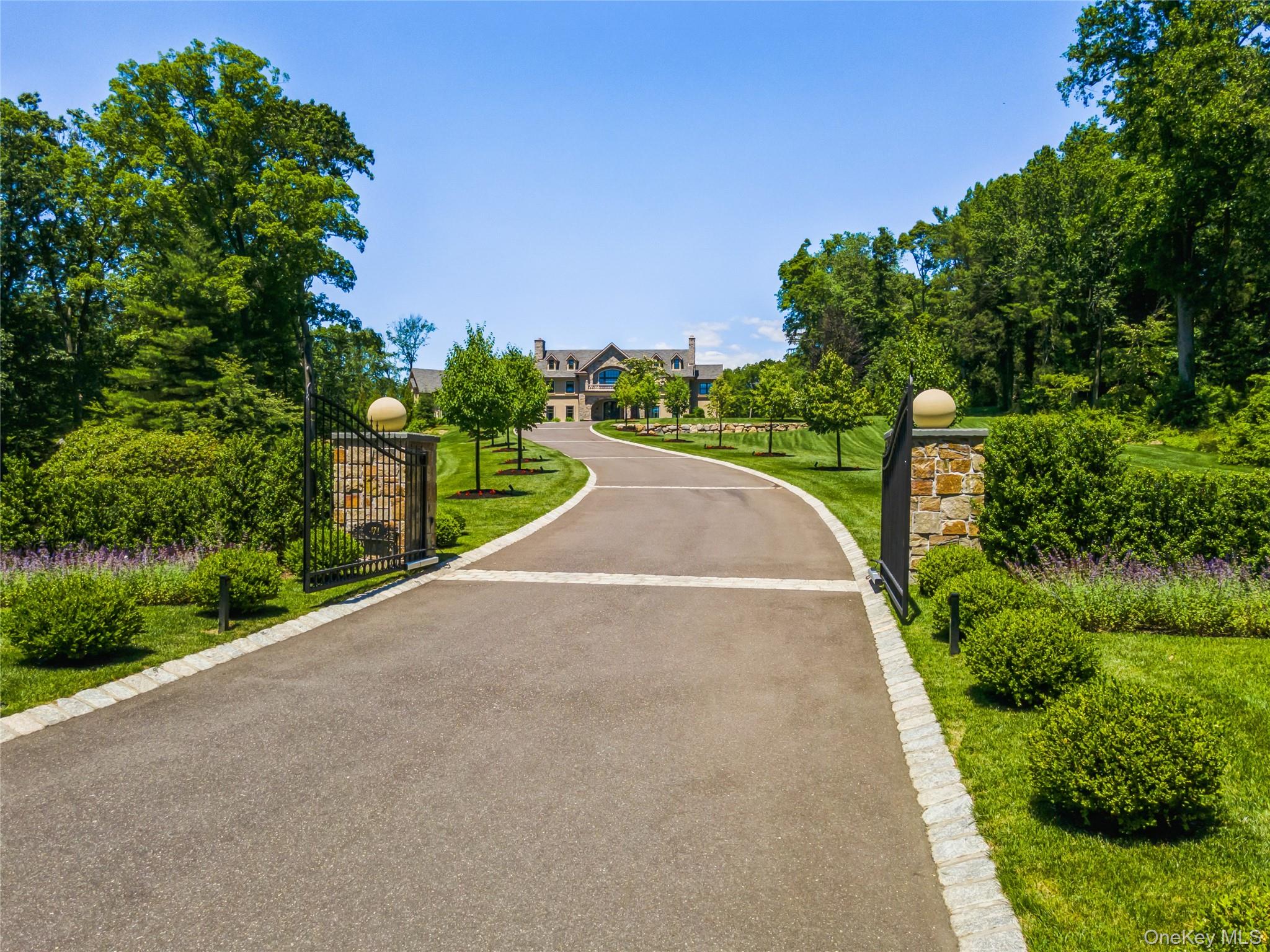 471 Woodbury Road Cold Spring Harbor, NY 11724 - Photo 2 of 36 a view of a street with a trees