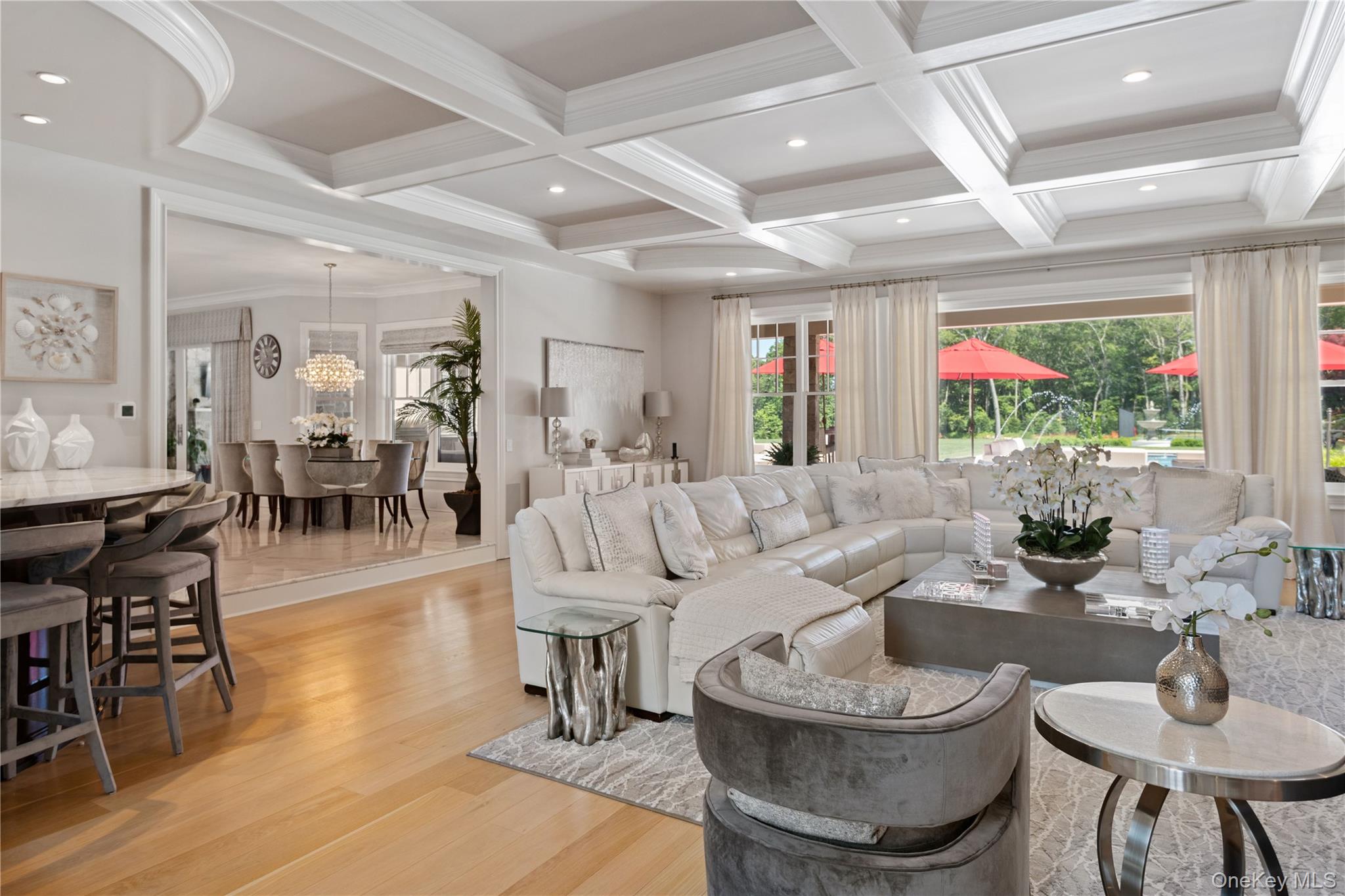 471 Woodbury Road Cold Spring Harbor, NY 11724 - Photo 7 of 36 a living room with couches and a dining table with wooden floor