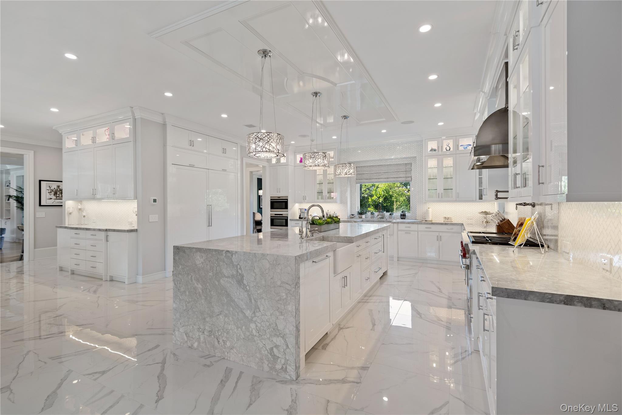 471 Woodbury Road Cold Spring Harbor, NY 11724 - Photo 8 of 36 a large white kitchen with lots of counter space and large windows