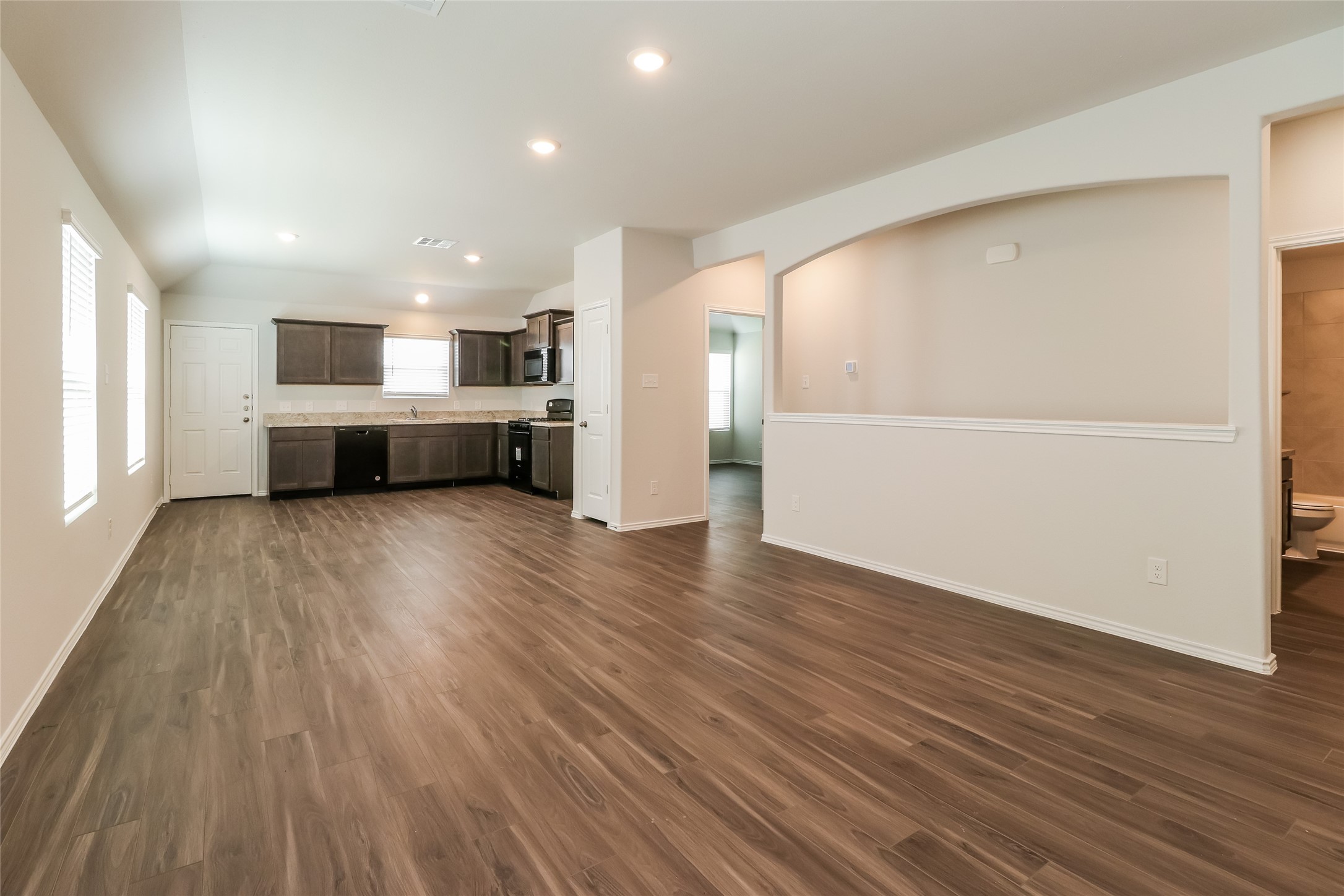 2501 Grayling Drive Conroe, TX 77384 - Photo 2 of 22 an empty room with wooden floor and windows