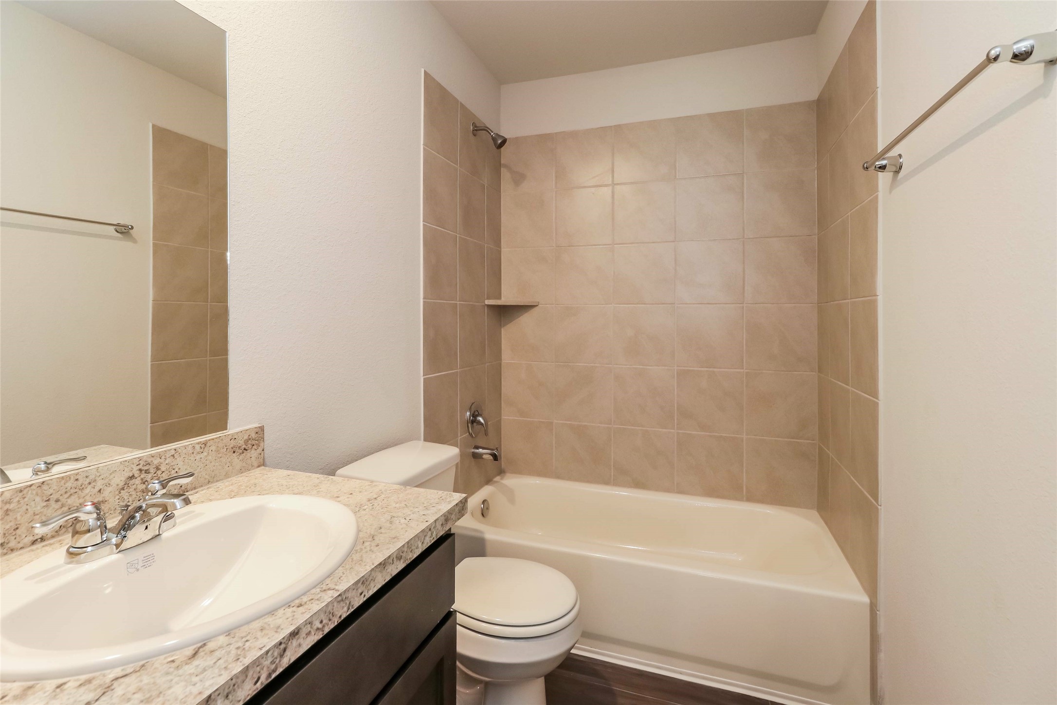 2501 Grayling Drive Conroe, TX 77384 - Photo 9 of 22 a bathroom with a granite countertop sink a toilet and shower