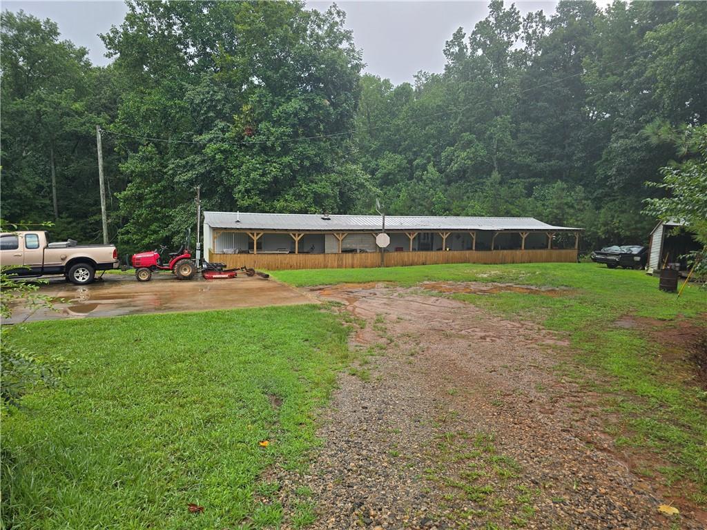 5725 Jot Em Down Road Cumming, GA 30041 - Photo 3 of 8 a view of a house with a big yard