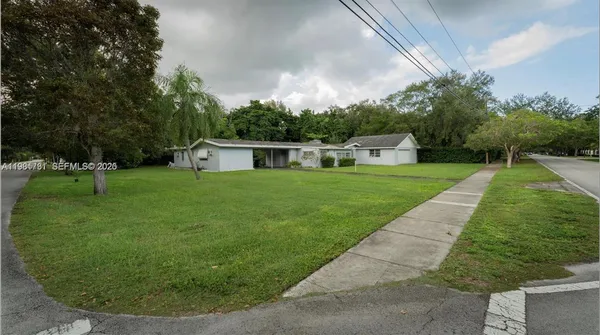 a view of a backyard with a garden and trees