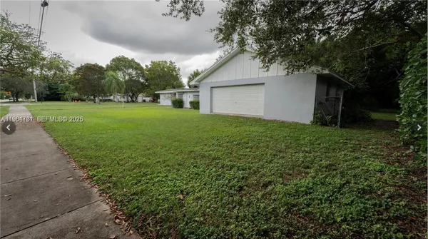 a view of a backyard with large trees