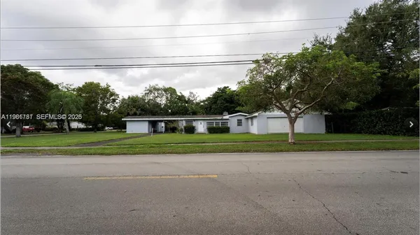 a front view of house with yard and green space