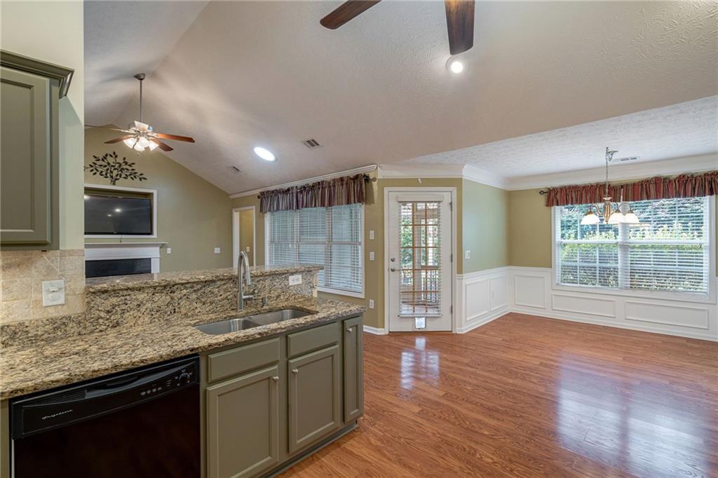 245 Memory Lane Winder, GA 30680 - Photo 20 of 62 a kitchen with stainless steel appliances granite countertop sink stove and wooden floor