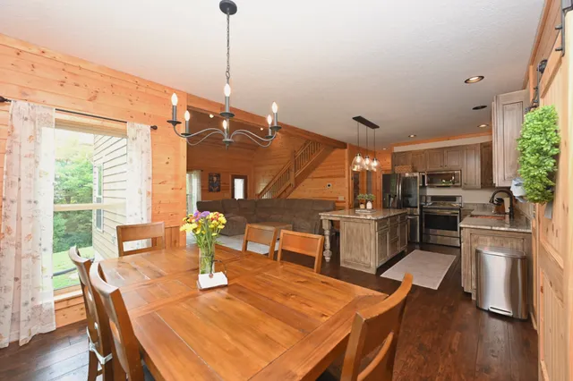 a dining room with furniture and a floor to ceiling window