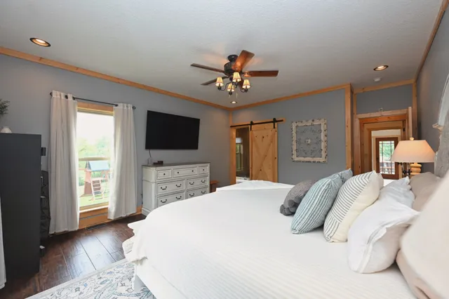 a bedroom with a bed and a flat screen tv