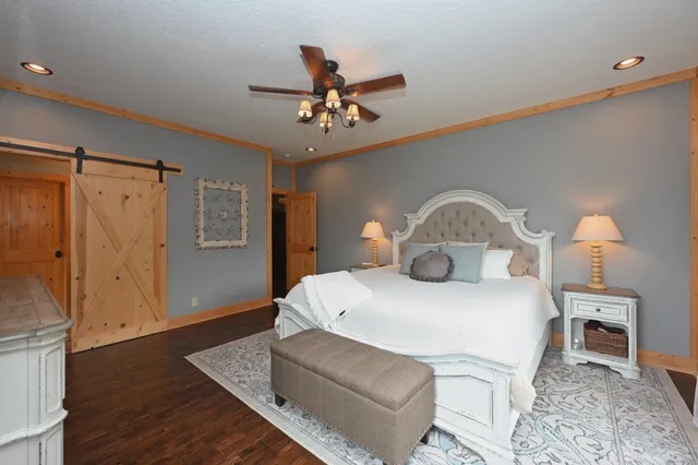 a bathroom with a granite countertop double vanity sink mirror and shower
