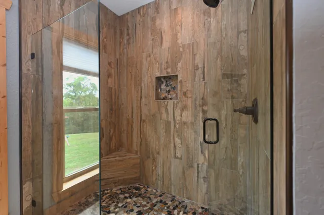 a en suite bathroom with a granite countertop sink and a mirror