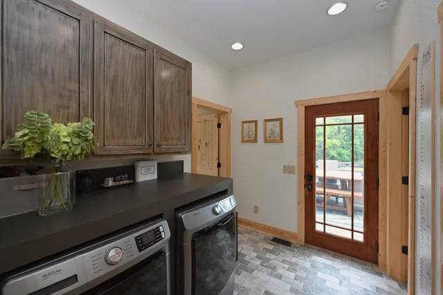 a kitchen with granite countertop a sink cabinets and wooden floor