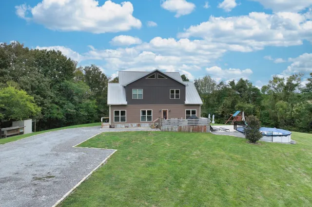 a view of a house with a yard and sitting area