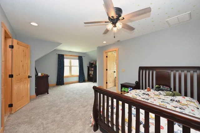 a bathroom with a granite countertop sink a toilet and shower