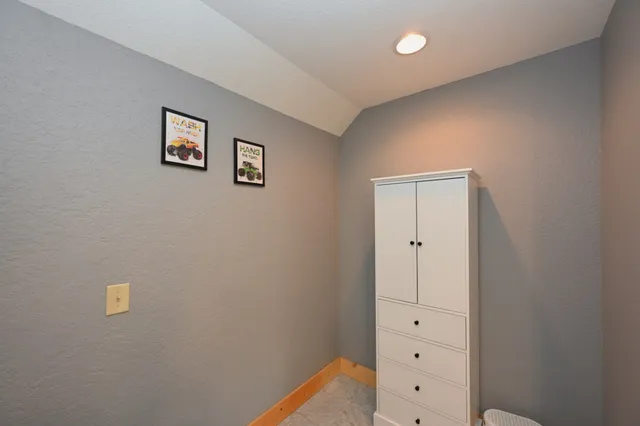 a bedroom with furniture and a chair