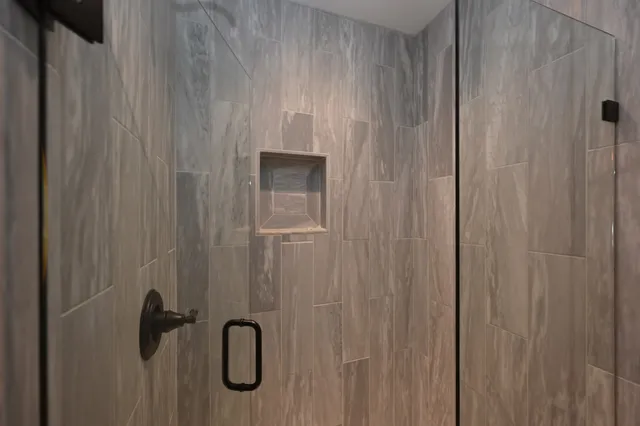 a view of a roof deck with table and chairs a barbeque with wooden floor and fence