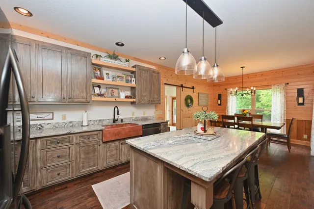 a kitchen with center island table and chairs in it