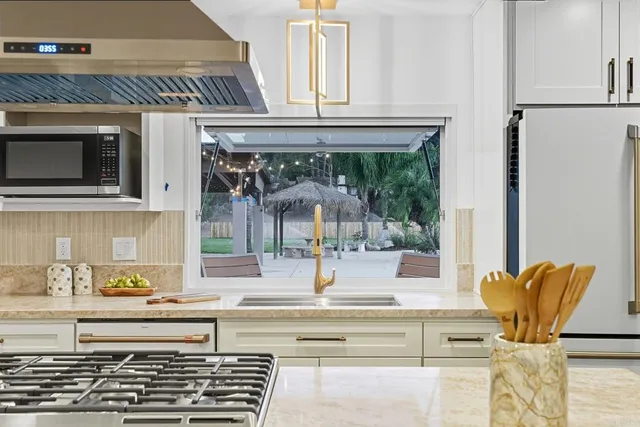 a living room with furniture wooden floor and large window