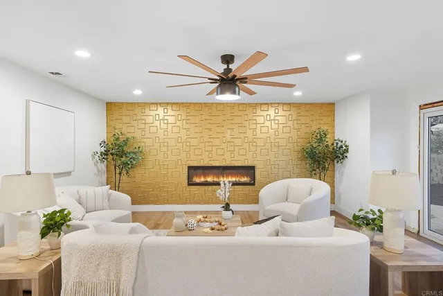 a dining room with furniture potted plants and wooden floor