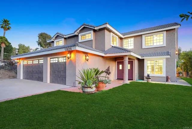 a kitchen with stainless steel appliances granite countertop a table chairs sink and cabinets