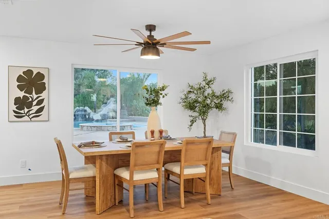 a bathroom with a sink a mirror a vanity and shower