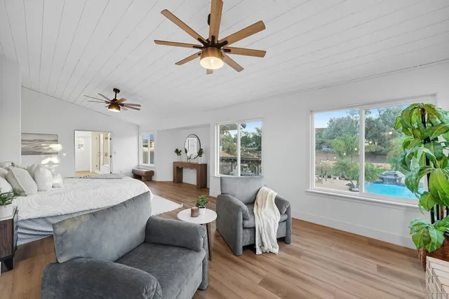 a bathroom with a granite countertop toilet sink and mirror
